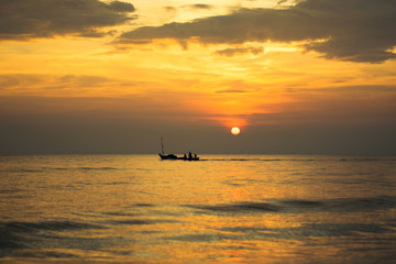 Fototapeta na wymiar silhouette of fishing boat on sunset sea