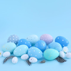 Easter eggs on blue background with empty space. Easter card
