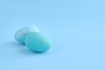 Easter eggs on blue background with empty space