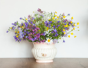 Mixed bouquet of wildflowers in an antique vase