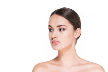 Fototapeta premium beautiful young woman with dotted line drawn on face for plastic surgery isolated on white