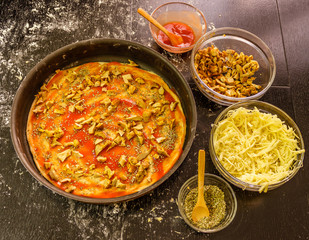 Preparing homemade vegetarian pizza with cheese and mushrooms