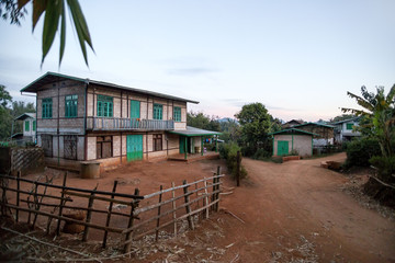 Two story building on a dirt road in a small Burmese farming village between Inle Lake and the town of Kalaw