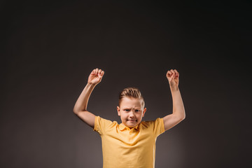 preteen angry boy gesturing, isolated on grey