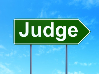 Law concept: Judge on green road highway sign, clear blue sky background, 3D rendering