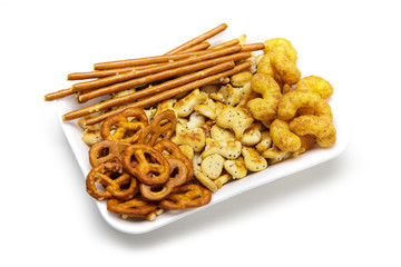 Salty snacks in plastic bowls, isolated on white