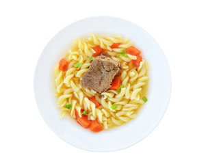 Bouillon clear beef broth with noodles and vegetables in white plate isolated, top view