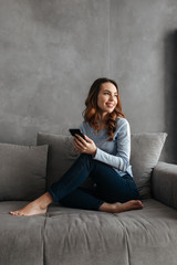 Portrait of a pretty young woman using mobile phone