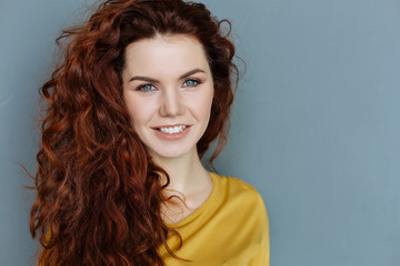 Beautiful face. Portrait of a cheerful delighted nice woman looking at you and smiling while being...