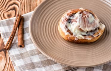Bun roll with cnnamon on a wooden table