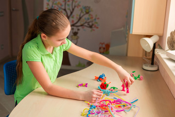 Cute little girl creating toys with chenille sticks