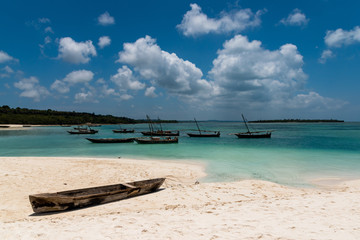 authentic African wooden fishing boats with beautiful clouds sky
