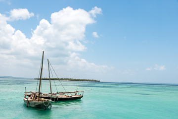 Obraz premium two authentic African wooden fishing boats,background ocean island 