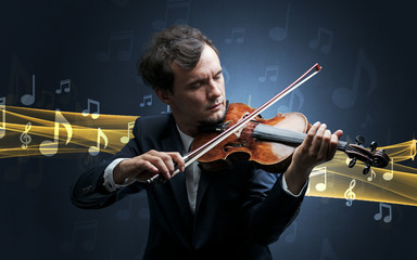 Fototapeta premium Young male musician playing on his violin with musical notes around