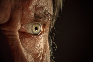 Close-up view on the eye of senior man.