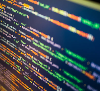 Orange, green and white php code on the dark blue background, closeup