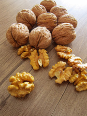 pecans and walnuts on a wooden floor would break.food background.