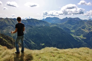 Trekker enjoying the view on the valley (Upper Seriana Valley). Orobie Alps, Lombardy, Italy © Renzo