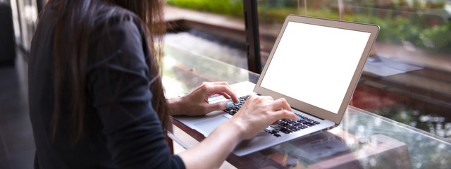 Blank screen with Beautiful young Asian girl working at a coffee shop with a laptop.female
