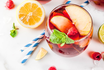 Summer cold cocktail, set of three fruit and berry sangria drink. red white pink, with apple, lemon, oranges and raspberry. light background, copy space