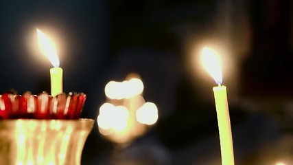 Candles burning in a candlestick in the church, close-up 
