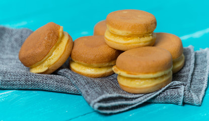 Cream Doughnut arranged on a wooden table in blue.