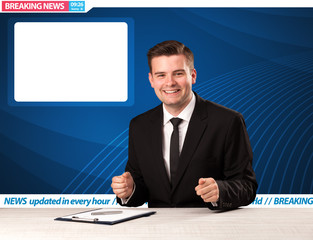 Television reporter telling breaking news at his studio desk with copy space concept