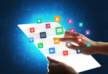 Young female hand holding a tablet with colorful mixed media icons