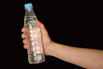 bottle with water in hand isolated on black background