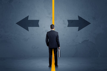 Business person choosing between two options separated by a yellow border arrow concept