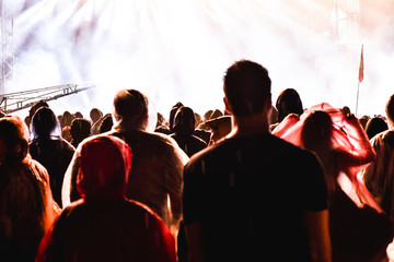 Cheering crowd in front of bright stage lights