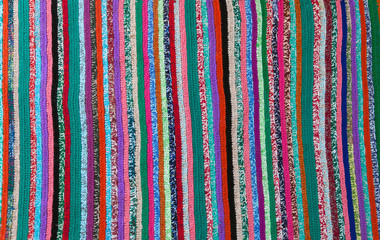 colorful carpet with strips knitted pattern, top view, flat lay