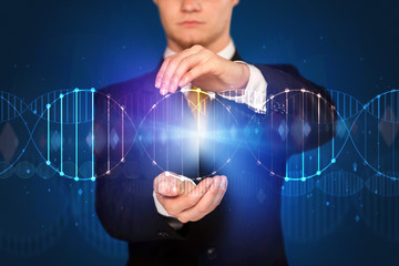 Businessman with DNA concept in his hands 