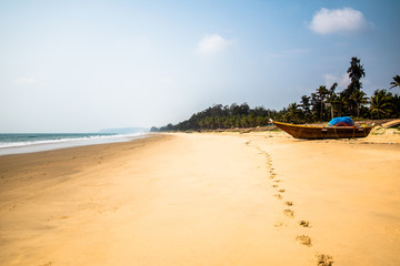 Fototapeta na wymiar Footprint on sand with boat