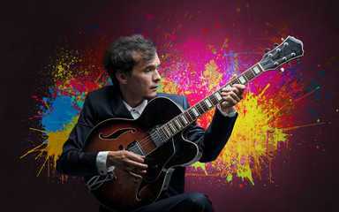 Obraz na płótnie Canvas Young classical guitarist musician with colorful splotch wallpaper