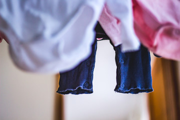 baby laundry hanging on a line-drying