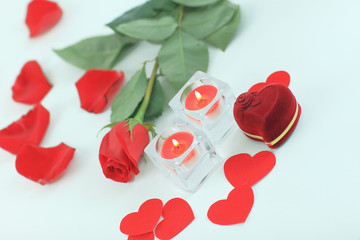 romantic concept . ring, candles and rose on white background