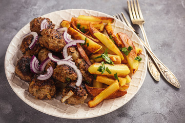Greek meatballs, keftedes, with fries.