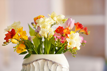 Beautiful bouquet of freesia flowers on blurred background