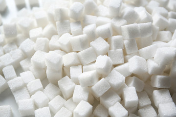 Fototapeta na wymiar Refined sugar cubes as background