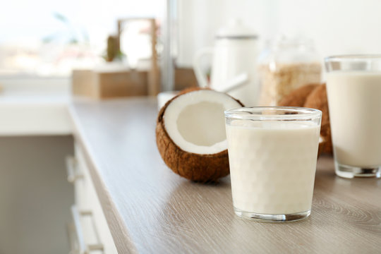 Glass with coconut milk on kitchen table