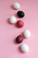 Easter multicolored colored eggs with beautiful texture on a pink background