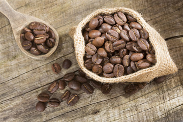 Roasted coffee on the wooden background - Coffee