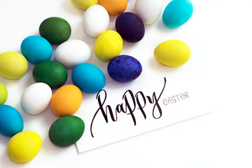 Easter festive colorful eggs on a white background. eggs yellow, blue, green and blue, orange and violet