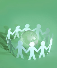 group of paper men standing around the glass globe