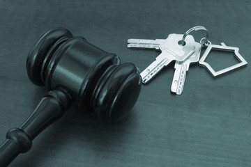 Judge gavel and keys on table, auction, buy, sale and court decision about real estate concept