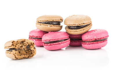 French macarons set (four pink with raspberry jam and two chocolate, one bitten) isolated on white background.