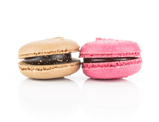 Two French macarons (chocolate and pink raspberry) isolated on white background.