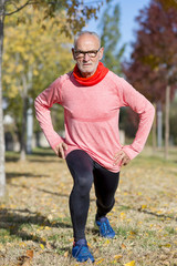 Senior man stretching after jogging in the park