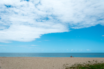 Fototapeta premium A man, a woman and a dog on the beach